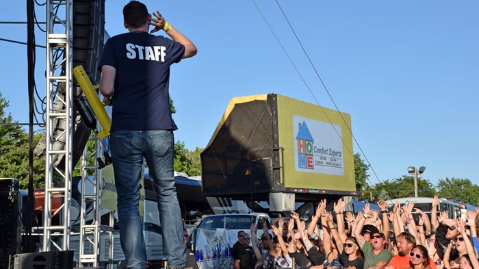 A B100 staff member prepares to shoot t-shirts to the crowd at the B100 Birthday Party