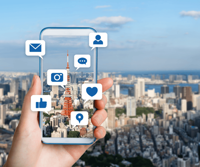 View of a city from above with an influencer taking a photo with cell phone to show effective influencer marketing